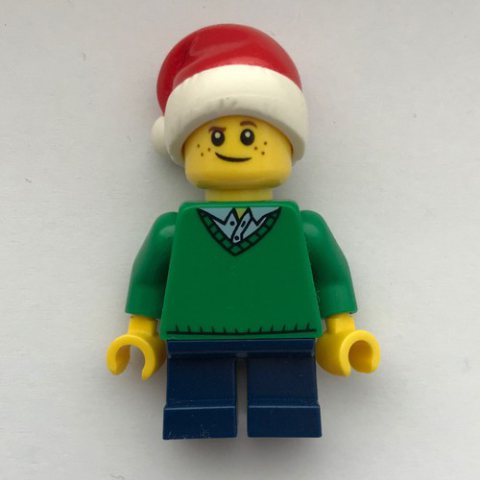 Minifigurka LEGO Boy, Green Sweater, Short Dark Blue Legs, Santa Hat