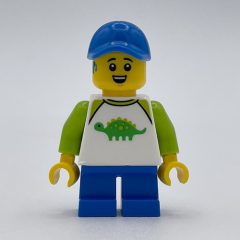 Minifigurka LEGO Boy, Dinosaur Shirt, Short Blue Legs, Blue Cap