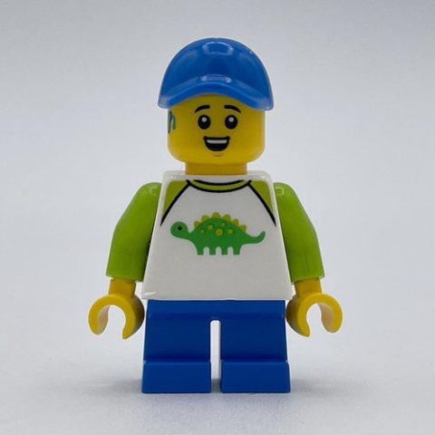 Minifigurka LEGO Boy, Dinosaur Shirt, Short Blue Legs, Blue Cap